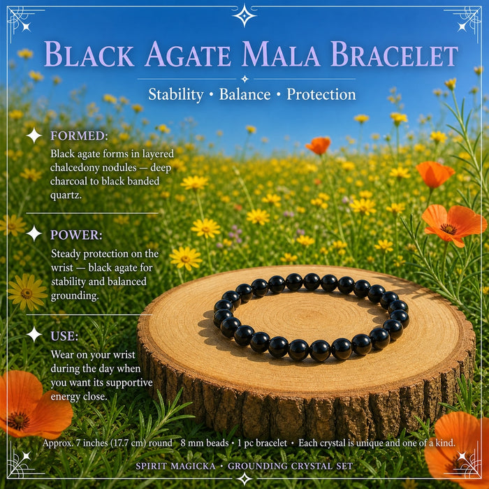A black agate bead mala bracelet on a wood round in a flower meadow