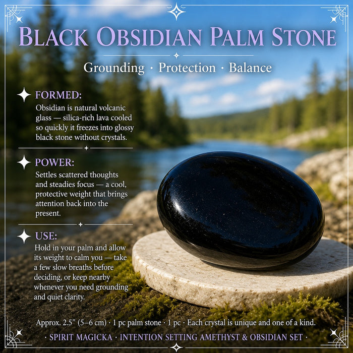 Glossy black obsidian palm stone on a stone slab by a lake