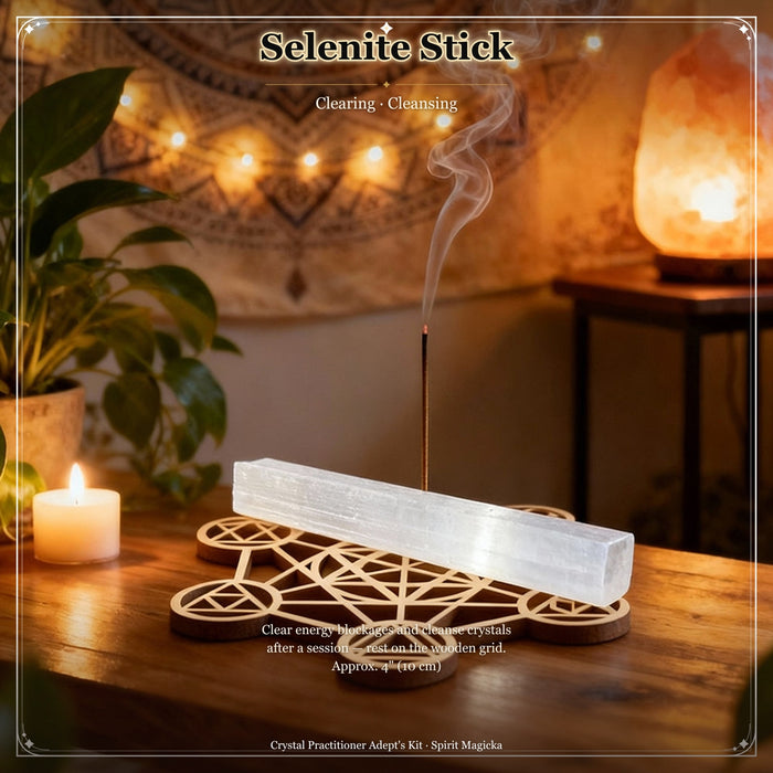 A white selenite stick resting on the wooden sacred geometry grid