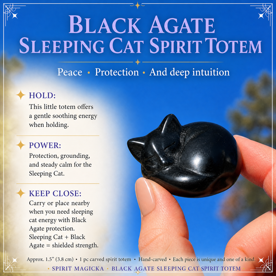 A black agate sleeping cat held between finger and thumb against a blue sky