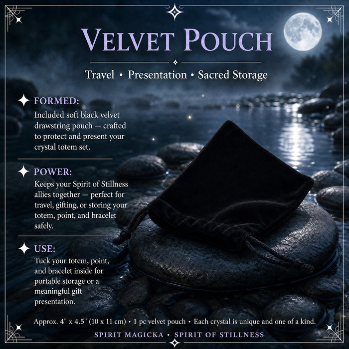 Black velvet drawstring pouch lying on a river stone