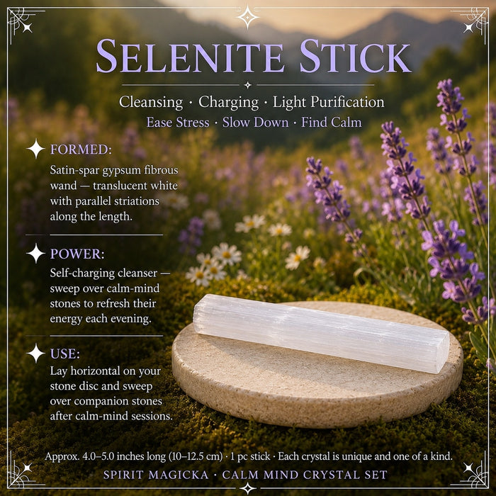 A satiny white selenite stick lying on a stone disc among lavender
