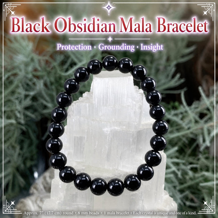Black obsidian bead mala bracelet displayed on a selenite piece
