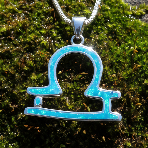 Close-up of the Libra glyph pendant inlaid with blue opal in a sterling silver setting