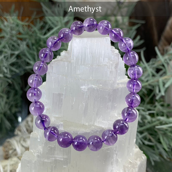 Amethyst bead bracelet on a selenite tower