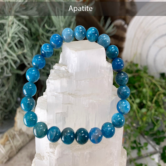 Deep blue apatite bead bracelet on a selenite tower