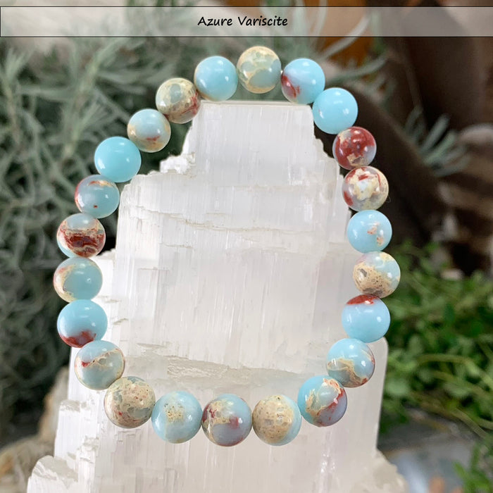 Sky blue azure variscite bead bracelet with cream and rust beads on a selenite tower