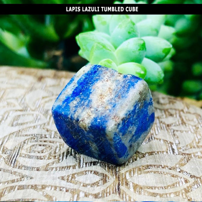 A tumbled lapis lazuli cube with softly rounded edges