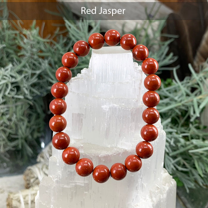 Red jasper bead bracelet on a selenite tower